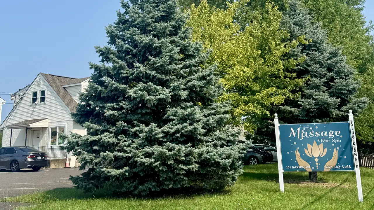 Jin’s Massage and Foot Spa outdoor sign beside green trees at 101 Jackson Ave in Glenside